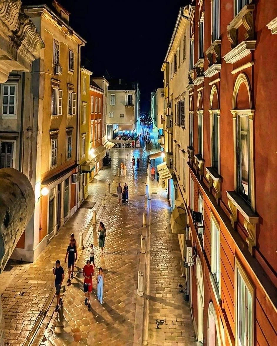 Cobblestone street in Rovinj old town at night with traditional Istrian architecture