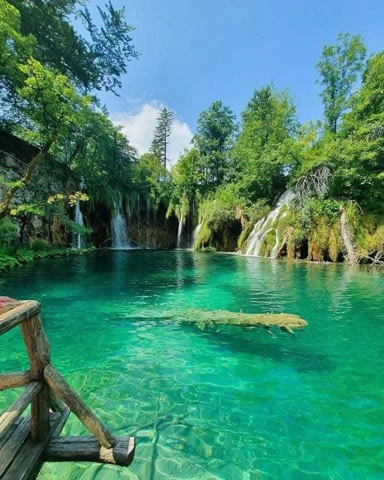 Cascading turquoise waterfalls between travertine ledges in Plitvice Lakes National Park, Croatia