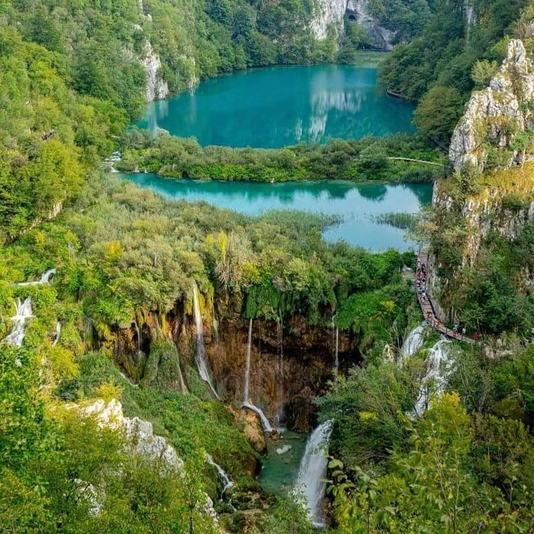 Panoramic view of multiple cascading waterfalls and emerald lakes in Plitvice Lakes National Park, Croatia